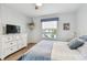 Bedroom with dresser, TV and coastal decor at 223 Sun Vista S Ct, Treasure Island, FL 33706