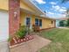 Front entrance with brick columns and a walkway at 2237 Spanish Vistas Dr, Dunedin, FL 34698