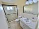 Bathroom with shower and tub, updated vanity, and tiled floors at 2311 Brisbane St # 65, Clearwater, FL 33763