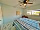 Bedroom with double bed, ceiling fan, and large window at 2311 Brisbane St # 65, Clearwater, FL 33763