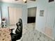 Well-lit bedroom with ceiling fan, desk, and modern marble-patterned flooring at 2311 Brisbane St # 65, Clearwater, FL 33763