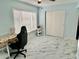 Bedroom with ceiling fan, desk, closet, and modern marble-patterned flooring at 2311 Brisbane St # 65, Clearwater, FL 33763