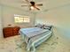 Bright bedroom with a double bed, dresser and ceiling fan at 2311 Brisbane St # 65, Clearwater, FL 33763