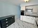 Bright kitchen featuring white cabinets, black countertops, and stainless steel microwave and oven at 2311 Brisbane St # 65, Clearwater, FL 33763