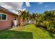 Backyard with palm trees and grassy lawn at 2351 Leslee Lake N Dr, St Petersburg, FL 33713