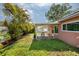 Backyard with patio cover and lush landscaping at 2351 Leslee Lake N Dr, St Petersburg, FL 33713