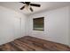 Simple bedroom with wood-look floors and sliding doors at 2351 Leslee Lake N Dr, St Petersburg, FL 33713