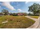 House with a large yard and a curved driveway at 2351 Leslee Lake N Dr, St Petersburg, FL 33713