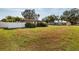 Side view of a pink house with a white fence and a large yard at 2351 Leslee Lake N Dr, St Petersburg, FL 33713