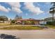 House with a pink exterior, landscaping, and a long driveway at 2351 Leslee Lake N Dr, St Petersburg, FL 33713