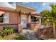 Inviting exterior of a charming single story home featuring a covered entryway and well-manicured landscaping at 2351 Leslee Lake N Dr, St Petersburg, FL 33713