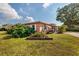 Side view of a pink house with landscaping and a small patio at 2351 Leslee Lake N Dr, St Petersburg, FL 33713