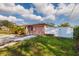 Side view of a pink house with a white fence and a driveway at 2351 Leslee Lake N Dr, St Petersburg, FL 33713