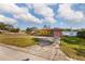 Pink house with a large yard and a long driveway at 2351 Leslee Lake N Dr, St Petersburg, FL 33713