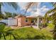 Home exterior showcasing a covered patio and landscaping at 2351 Leslee Lake N Dr, St Petersburg, FL 33713