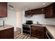 Well-equipped kitchen featuring stainless steel appliances and dark wood cabinetry at 2351 Leslee Lake N Dr, St Petersburg, FL 33713