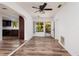 Open concept living room with wood-look flooring and access to the kitchen and backyard at 2351 Leslee Lake N Dr, St Petersburg, FL 33713