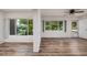 Living room with large windows, hardwood floors and an open floor plan at 2351 Leslee Lake N Dr, St Petersburg, FL 33713