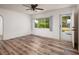 Bright and airy living room with wood-look flooring and a view of the lush tropical backyard at 2351 Leslee Lake N Dr, St Petersburg, FL 33713