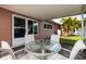 Covered patio with table and chairs, overlooking backyard at 2351 Leslee Lake N Dr, St Petersburg, FL 33713