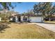 Single story home with attached garage and landscaping at 23523 Shining Star Dr, Land O Lakes, FL 34639