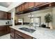 Kitchen island with granite countertop and double sink at 23523 Shining Star Dr, Land O Lakes, FL 34639