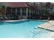 Relaxing pool area with lounge chairs and patio tables at 2400 Feather Sound Dr # 717, Clearwater, FL 33762