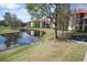 Picturesque view of a tranquil lake and condo building at 2400 Feather Sound Dr # 717, Clearwater, FL 33762