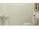 Clean bathroom with pedestal sink and toilet at 2635 Sunray Venus Way, Ruskin, FL 33570