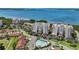 Scenic aerial of condos featuring a beautiful waterfront, swimming pool, and lush green landscaping at 2825 Terra Ceia Bay Blvd # 1504, Palmetto, FL 34221