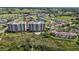 Stunning aerial shot of a condo complex, showcasing a pool, golf course, and serene ponds at 2825 Terra Ceia Bay Blvd # 1504, Palmetto, FL 34221