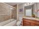 This bathroom offers a shower-tub combo with glass doors, matched with a granite-topped vanity at 2825 Terra Ceia Bay Blvd # 1504, Palmetto, FL 34221