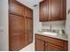 Convenient laundry room featuring plenty of storage space and a sink with granite countertop at 2825 Terra Ceia Bay Blvd # 1504, Palmetto, FL 34221