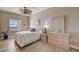 Cozy bedroom with a ceiling fan, large window, and dresser with decorative seashell accents at 2825 Terra Ceia Bay Blvd # 1504, Palmetto, FL 34221