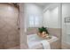 Bathroom with soaking tub, shower, and neutral tile at 351 46Th N Ave, St Petersburg, FL 33703