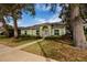 Light green house with a landscaped yard and walkway at 351 46Th N Ave, St Petersburg, FL 33703