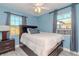 Cozy bedroom with a queen-size bed, ceiling fan, and two windows at 4751 Fairfield S Ave, St Petersburg, FL 33711