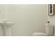 Clean and simple bathroom with pedestal sink and toilet at 5190 Meyer Bessie St, Zephyrhills, FL 33541