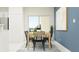 Bright dining area with a wooden table and access to the backyard at 5190 Meyer Bessie St, Zephyrhills, FL 33541