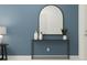 Stylish entryway with a modern console table and arched mirror at 5190 Meyer Bessie St, Zephyrhills, FL 33541