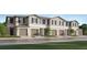 Modern townhome community with attached garages and well-manicured lawns at 5190 Meyer Bessie St, Zephyrhills, FL 33541
