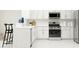 Modern kitchen featuring stainless steel appliances and white cabinetry at 5190 Meyer Bessie St, Zephyrhills, FL 33541