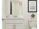 Simple bathroom with white vanity, toilet and mirror at 5210 Meyer Bessie St, Zephyrhills, FL 33541