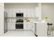 Modern kitchen with white cabinets and stainless steel appliances at 5210 Meyer Bessie St, Zephyrhills, FL 33541