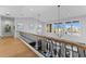 Light-filled hallway featuring hardwood floors, an open railing, and large windows at 5308 E Longboat Blvd, Tampa, FL 33615