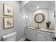 Elegant powder room features a marble vanity, decorative mirror, and stylish wallcovering at 5308 E Longboat Blvd, Tampa, FL 33615