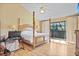 Main bedroom with private balcony access and wood floors at 5340 Cobblestone Ct, Wesley Chapel, FL 33543