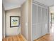 Bright hallway with linen closet and wood floors at 5340 Cobblestone Ct, Wesley Chapel, FL 33543
