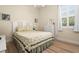 Charming bedroom with light wood flooring and a queen bed at 5571 Rock Dove Dr, Sarasota, FL 34241