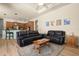 Living room with black leather couches and kitchen view at 5571 Rock Dove Dr, Sarasota, FL 34241